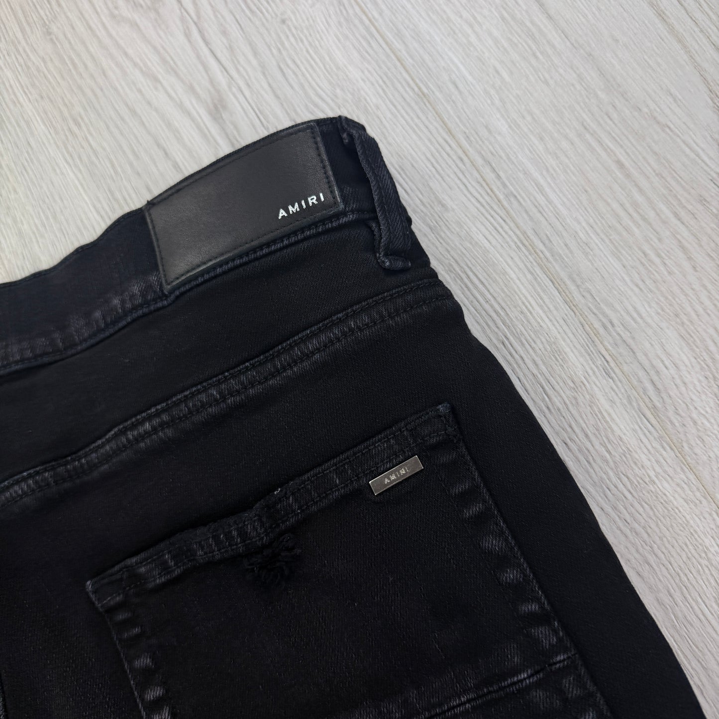 Amiri MX1 Men’s Black Distressed Core Camouflage Applique Jeans