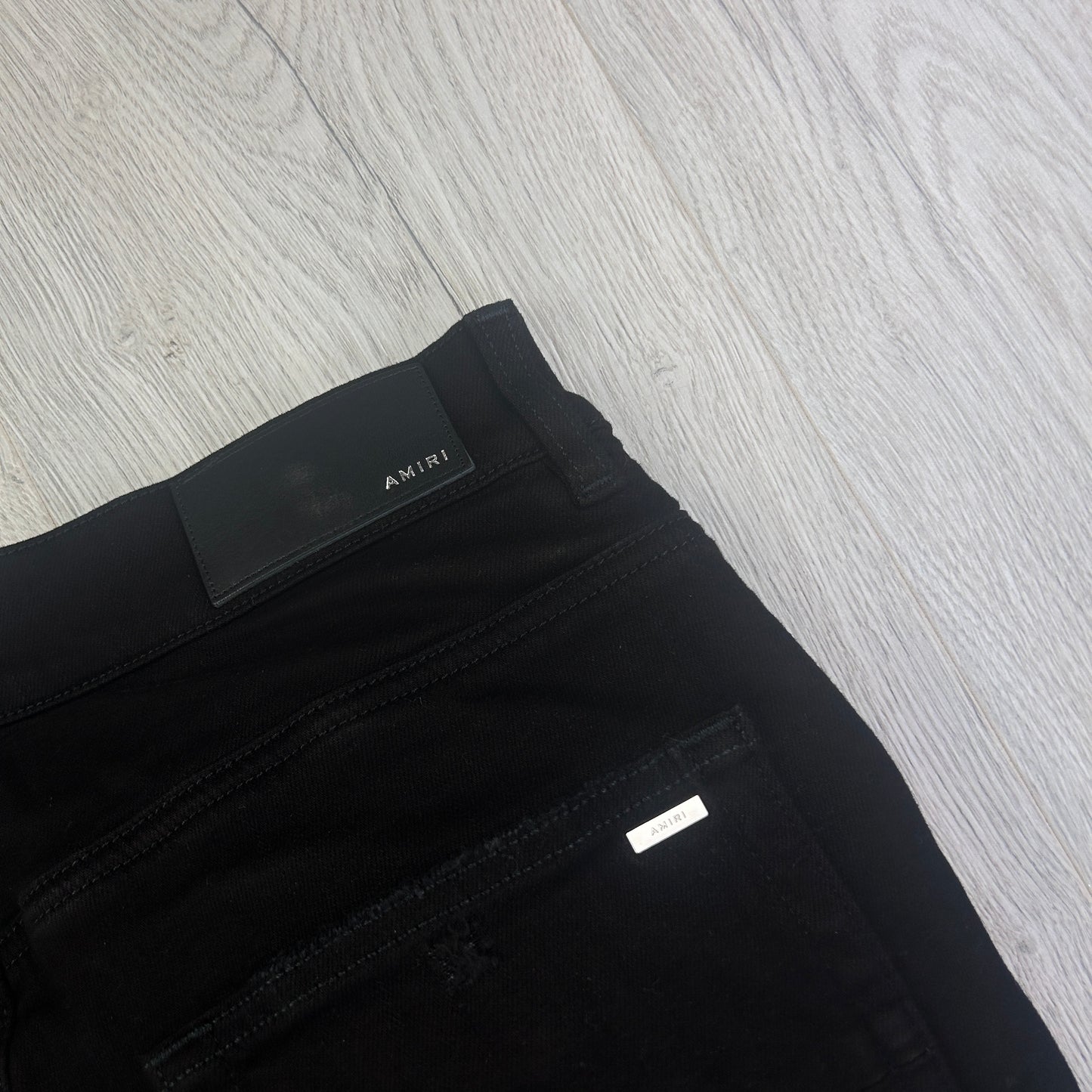 Amiri MX1 Men’s Black Distressed Jeans With Blue Side Logo