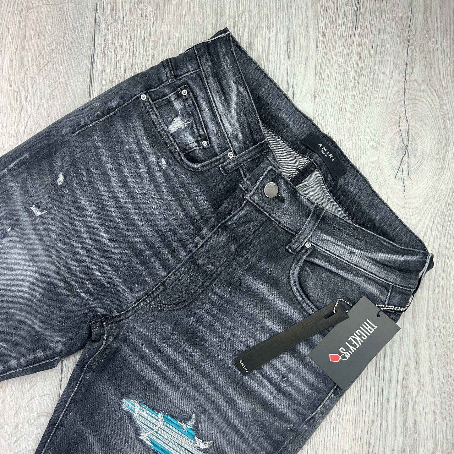 Amiri Men’s MX1 Black Distressed Jeans Blue Patch
