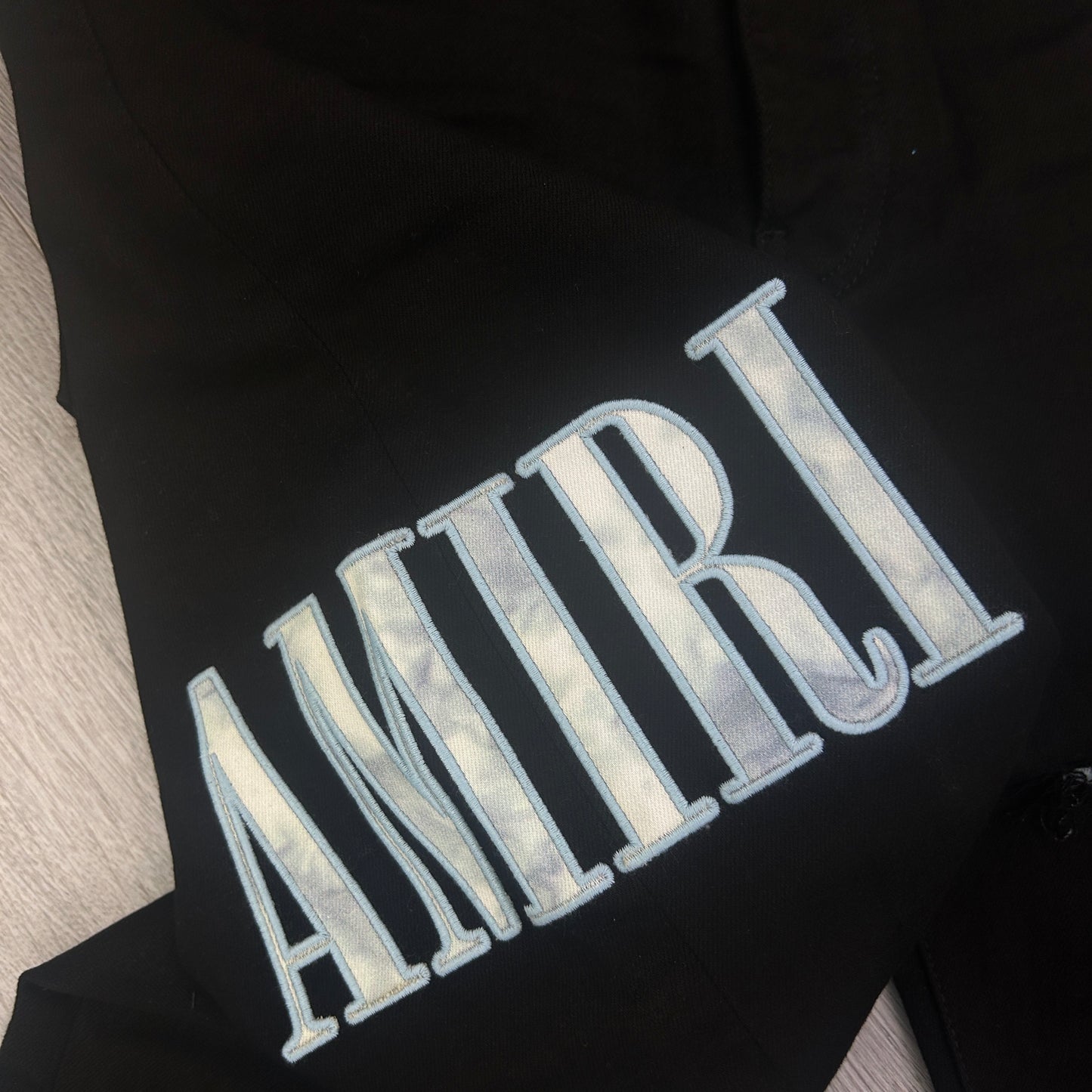 Amiri MX1 Men’s Black Distressed Jeans With Blue Side Logo