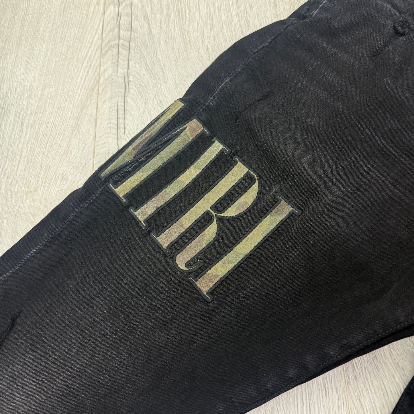 Amiri MX1 Men’s Black Distressed Core Camouflage Applique Jeans