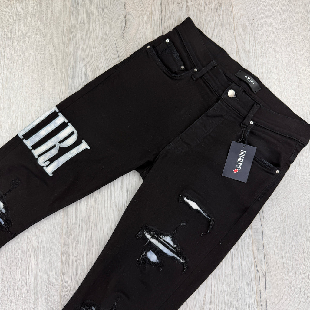 Amiri MX1 Men’s Black Distressed Jeans With Blue Side Logo