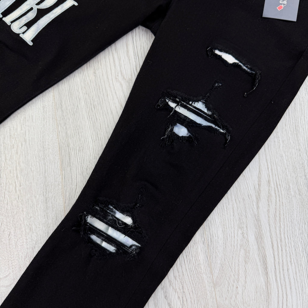 Amiri MX1 Men’s Black Distressed Jeans With Blue Side Logo