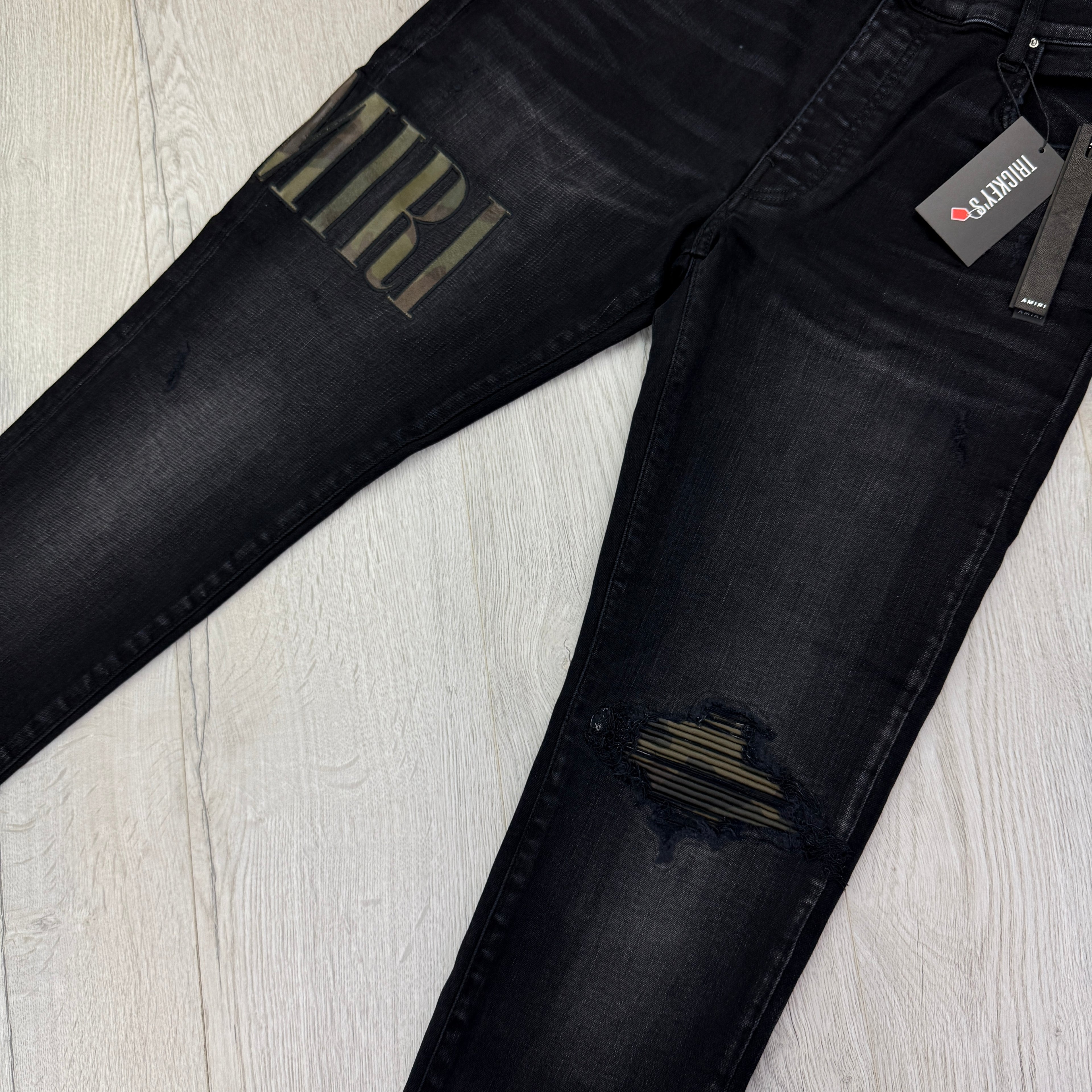 Amiri MX1 Men’s Black Distressed Core Camouflage Applique Jeans