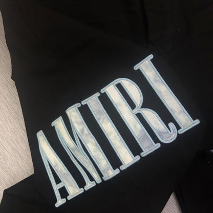 Amiri MX1 Men’s Black Distressed Jeans With Blue Side Logo