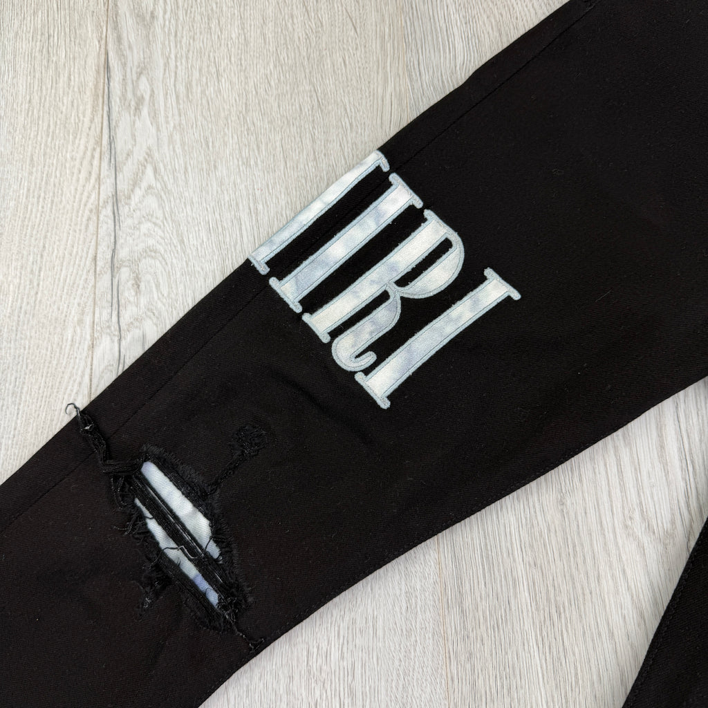 Amiri MX1 Men’s Black Distressed Jeans With Blue Side Logo